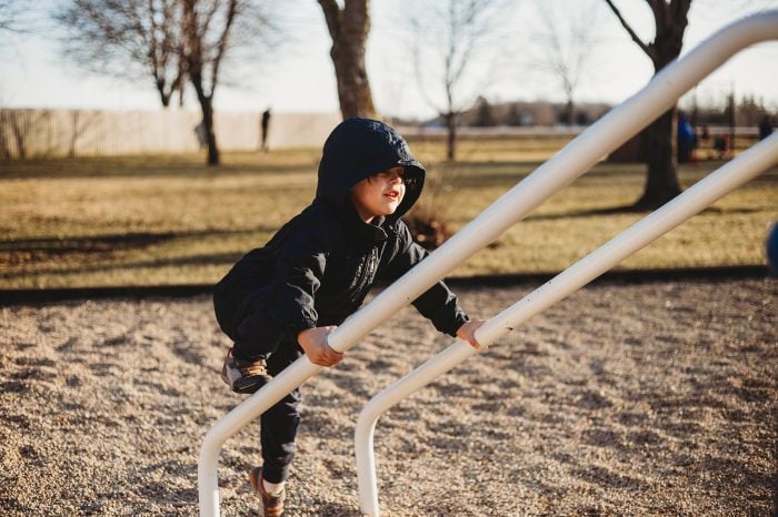 Child climbing a jungle gym