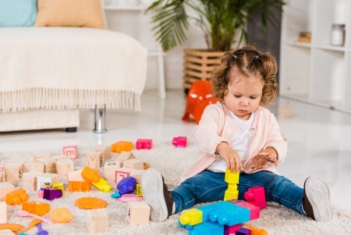 Little girl playing with lego