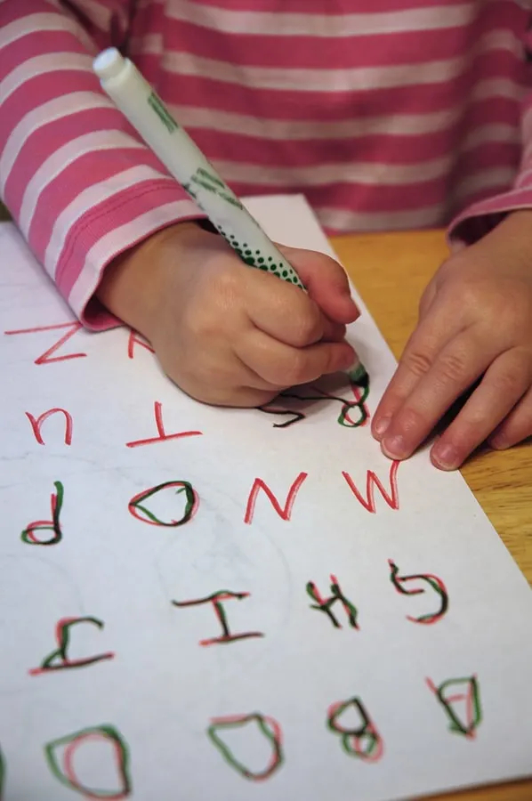 Preschooler tracing letters