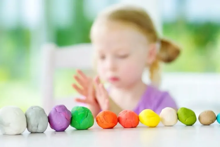 child playing with playdough