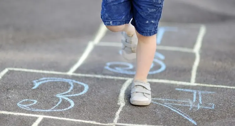 child playing hopscotch