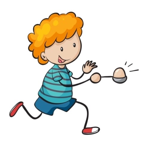 Young boy doing an egg and spoon race