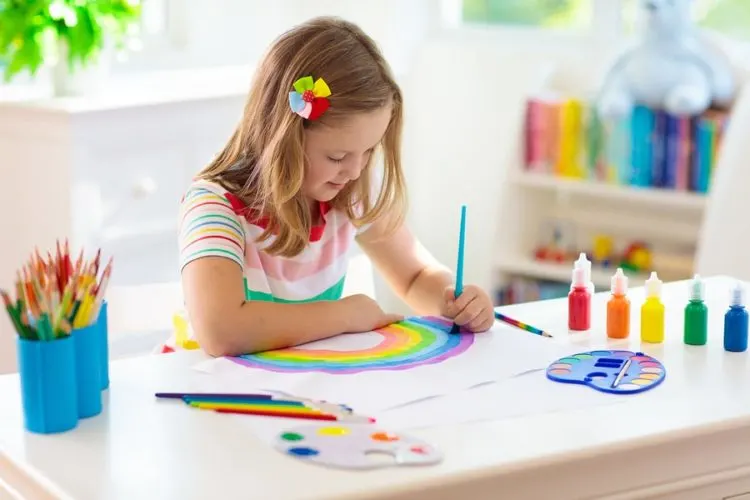Young girl painting at her desk