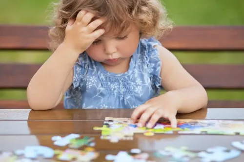 Toddler completing puzzle