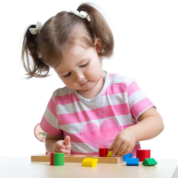 Child holding puzzle pieces