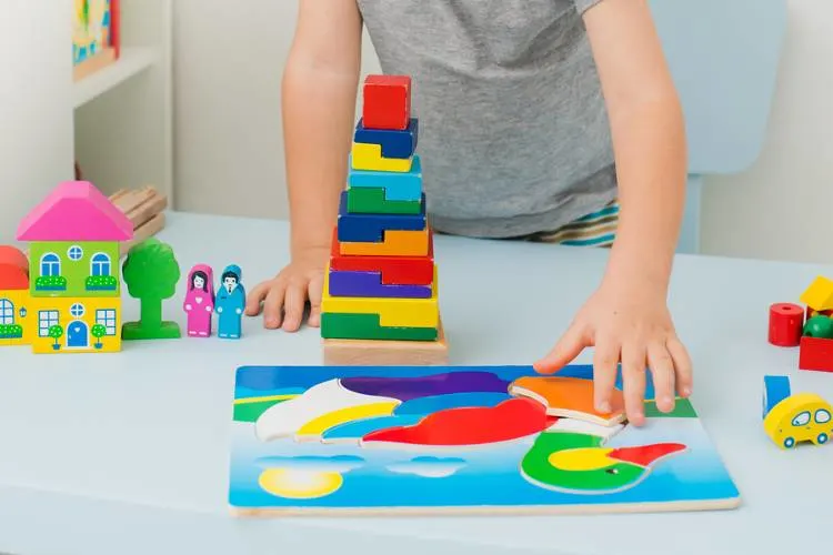 Toddler completing a puzzle of a duck.