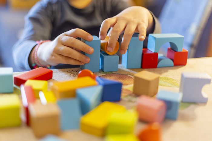 Child building with wooden blocks