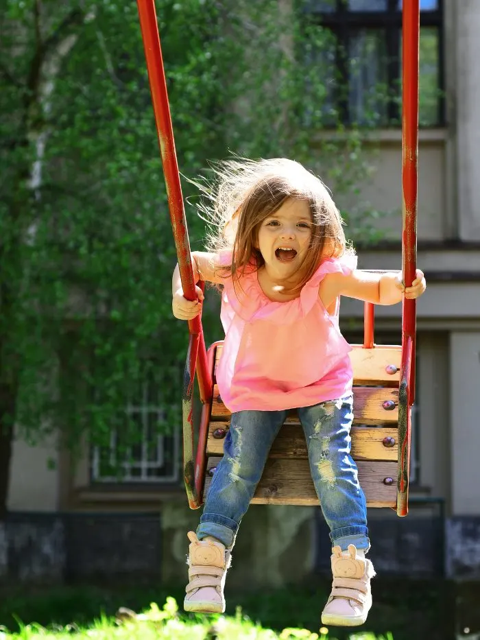 Child playing on swing