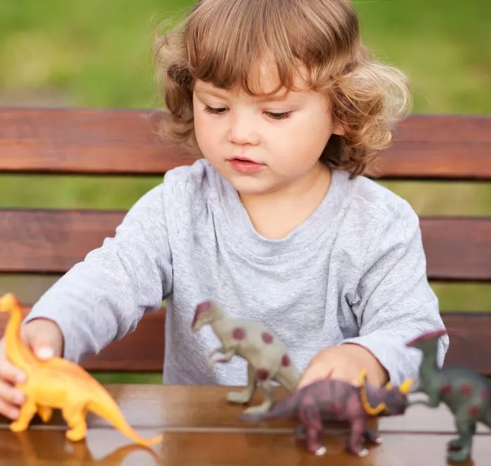 Child playing with dinosaurs