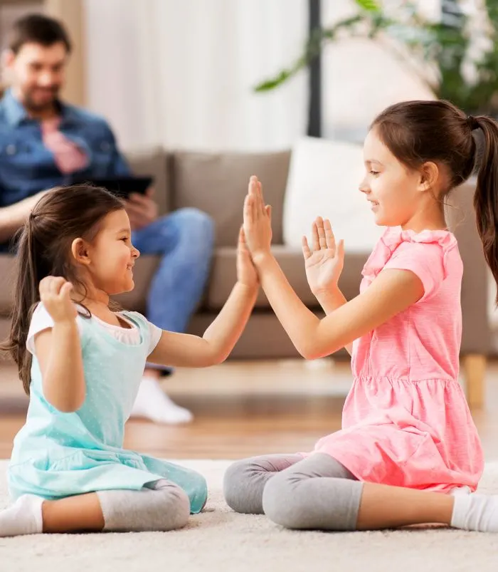 Children playing a clapping game and crossing the midline game