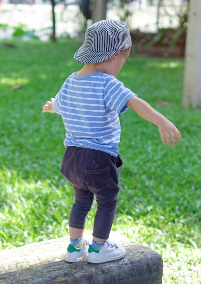 Child balancing on a beam