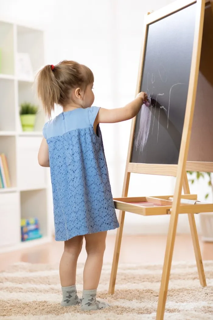 Child drawing at an easel