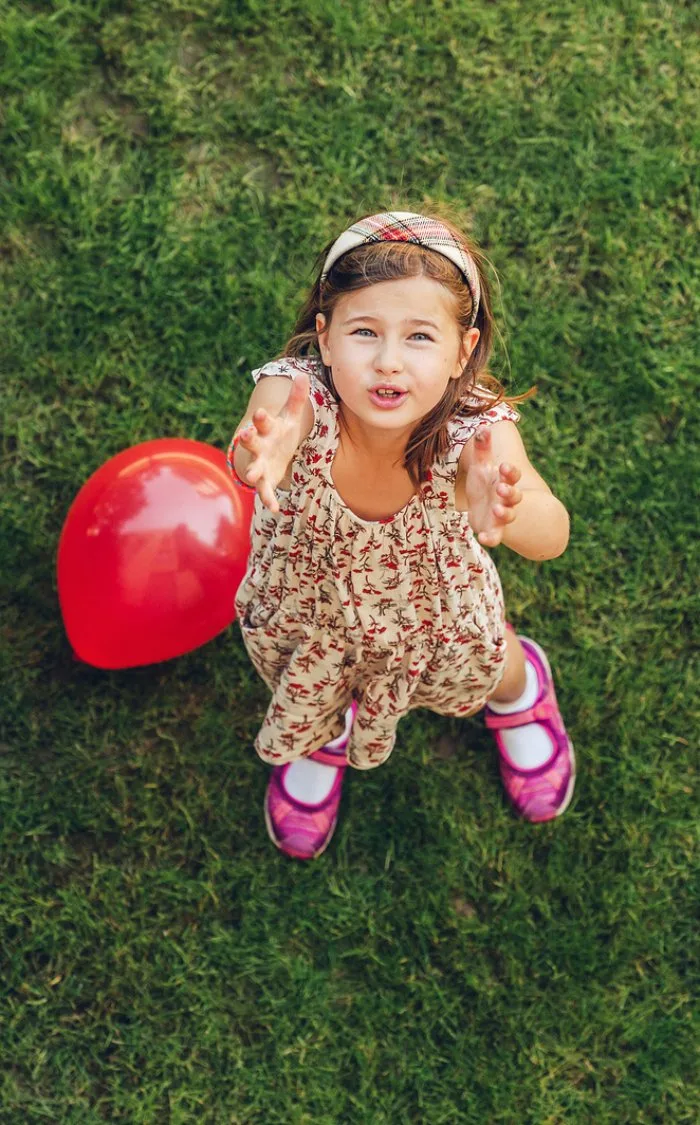 Child playing with balloon