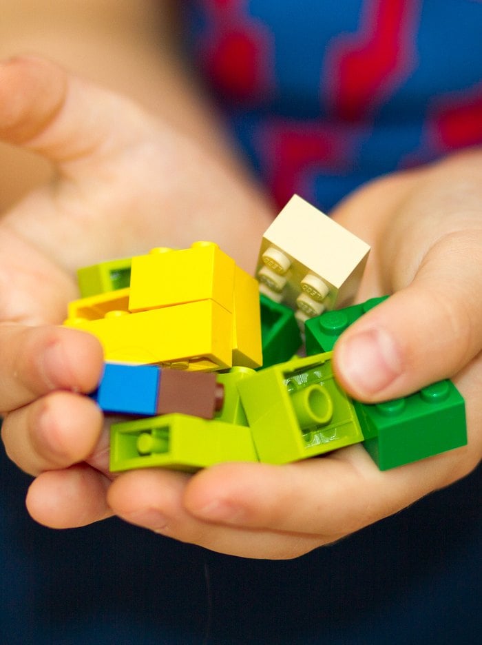 Child holding Lego bricks