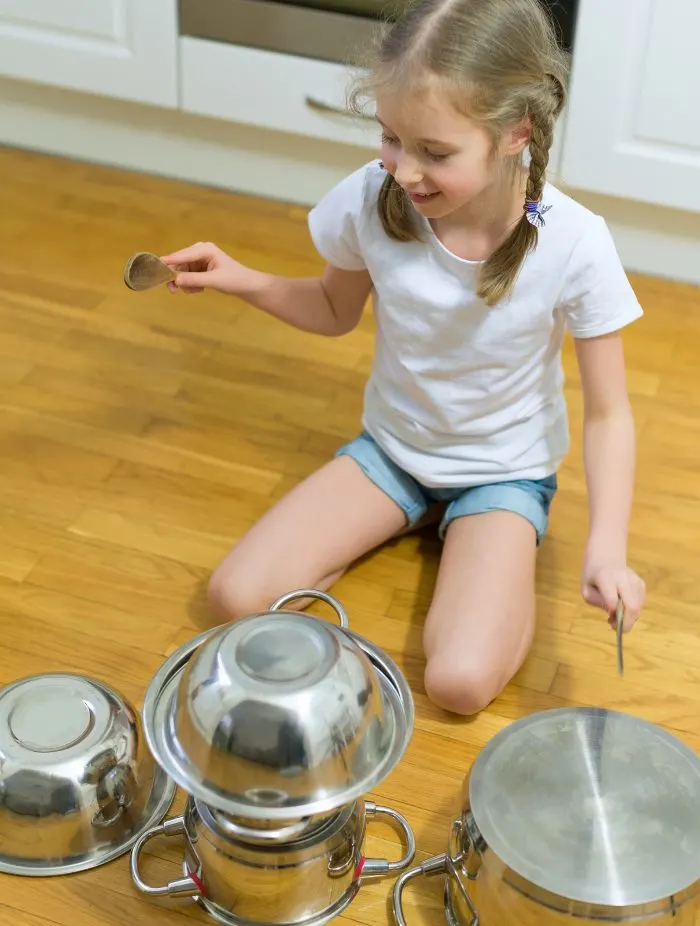 Child using pots as a drum set