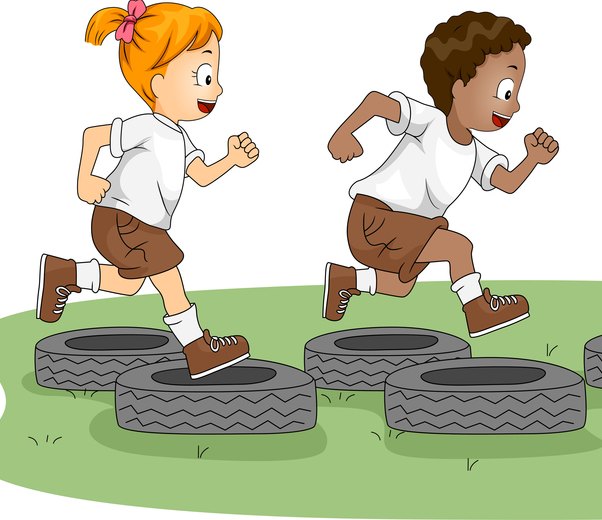 Children hopping into tyres