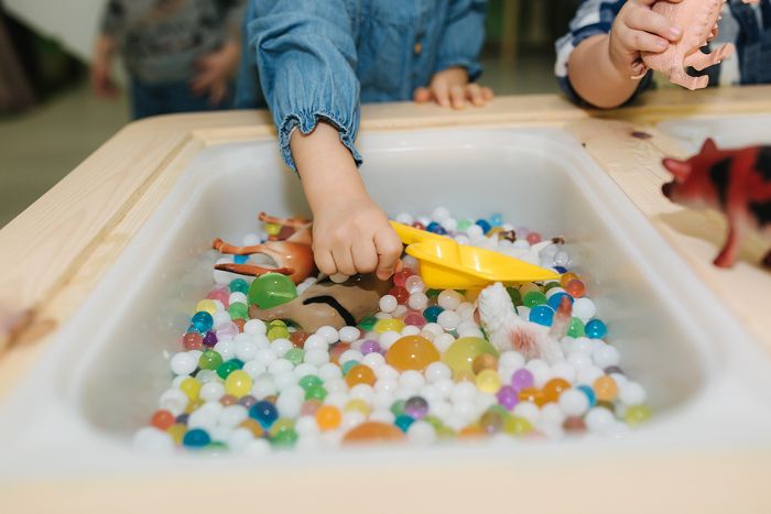 Child playing at messy play table.