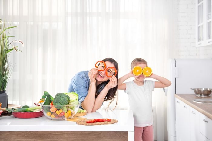 Mom and daughter playing with fruit