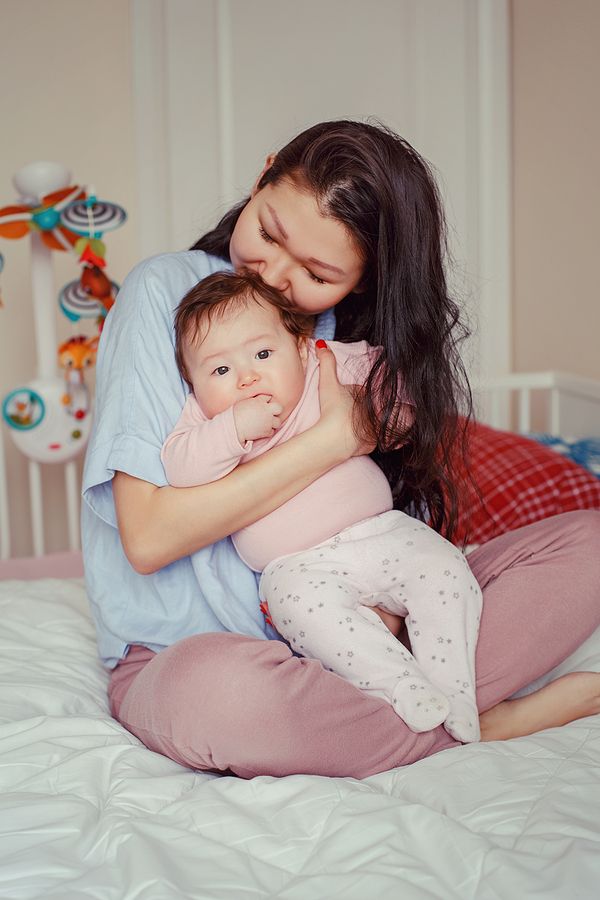 Mother embracing infant