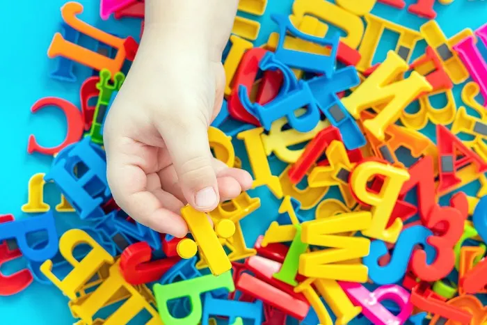 Child playing with magnetic letters