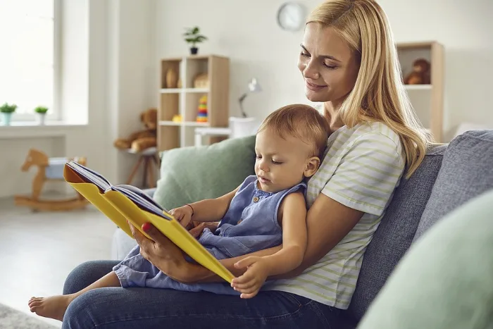 Mom reading a book to toddler 