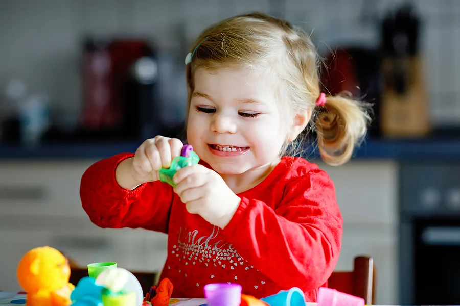 Little toddler playing with playdough