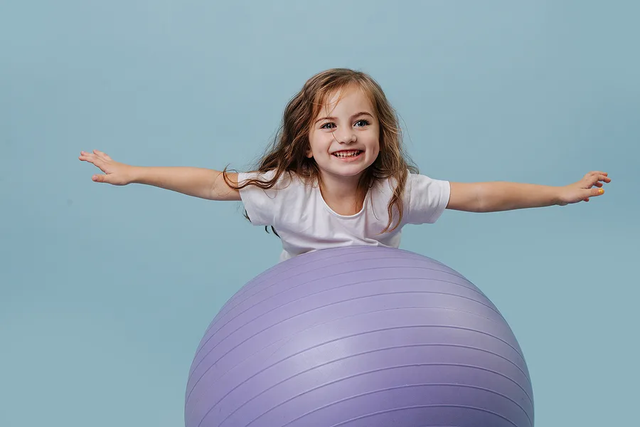 Kid balancing on an exercise ball