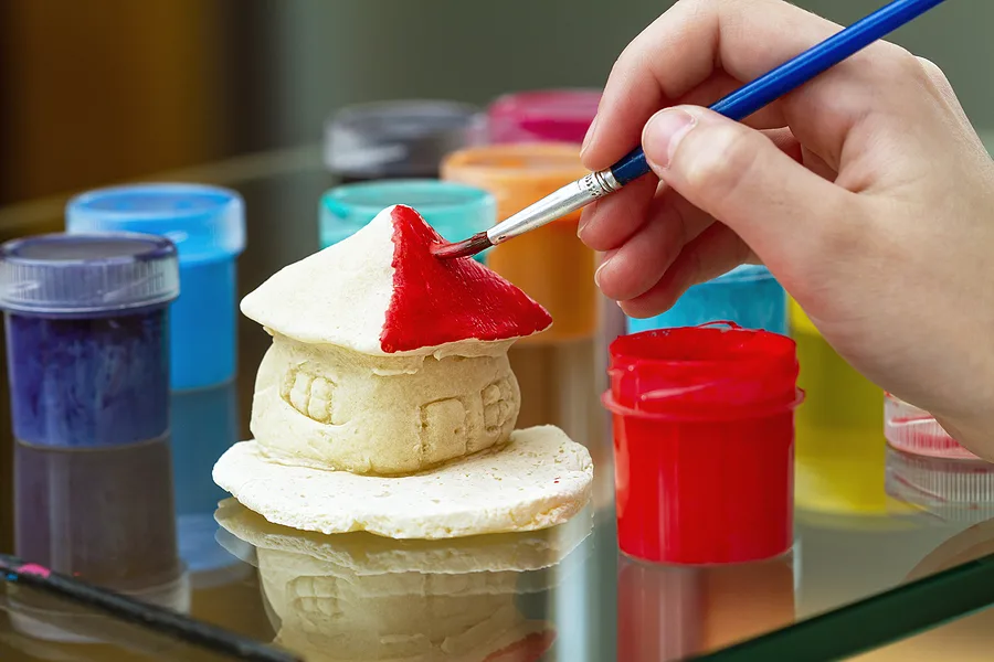 Painting a house made out of playdough