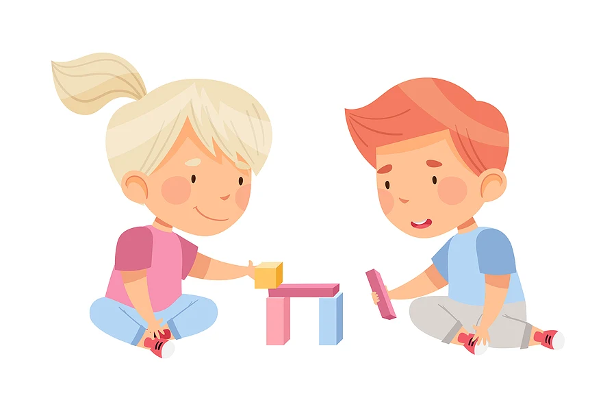 Two kids stacking blocks together