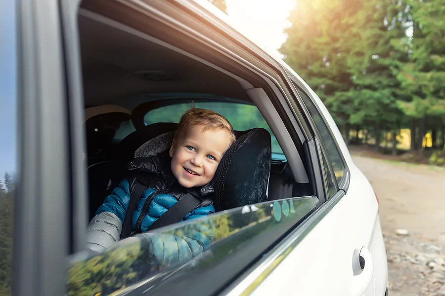 Child looking out the window in the car 