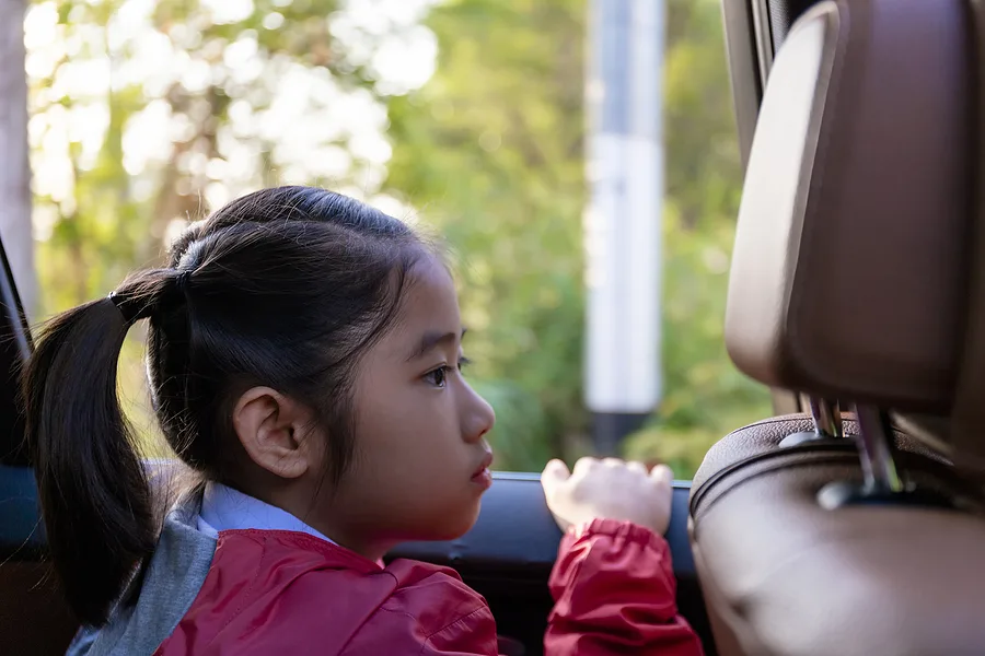 Child looking out the car window.