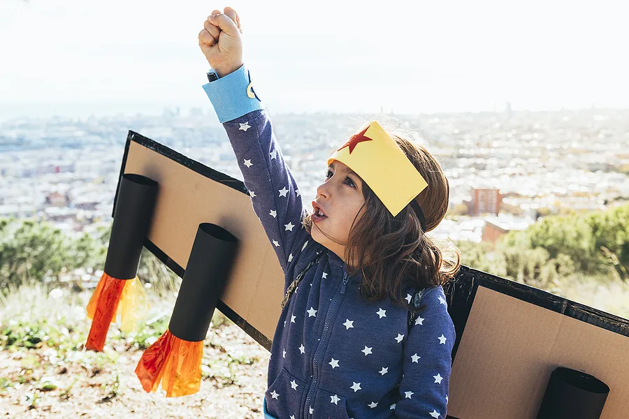 child pretending to fly an airplane