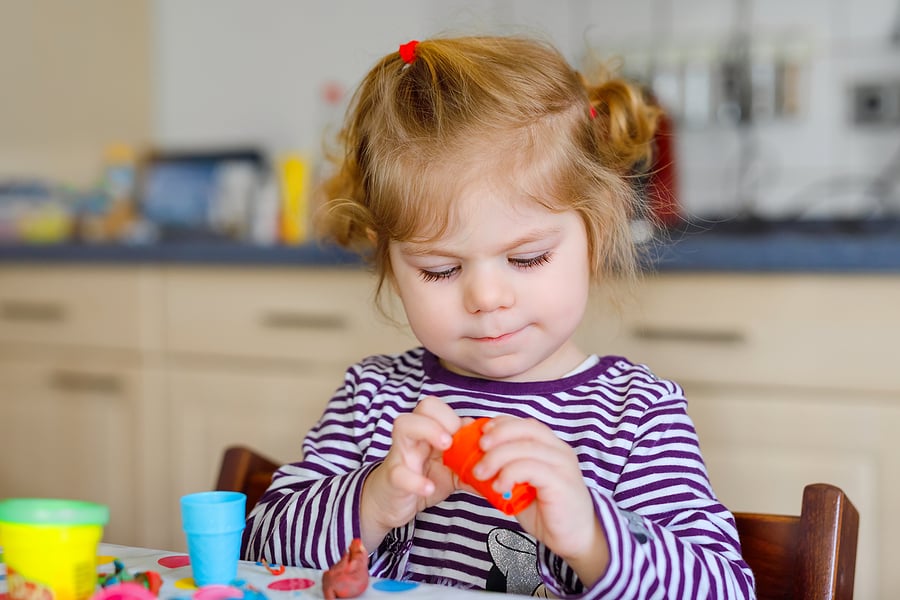 Preschooler playing with playdough