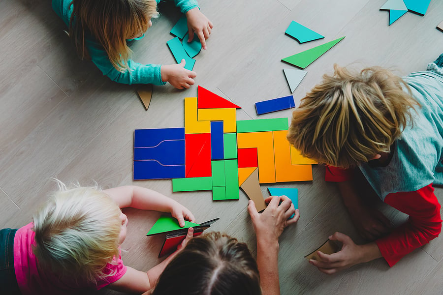 Children playing with tangram shapes