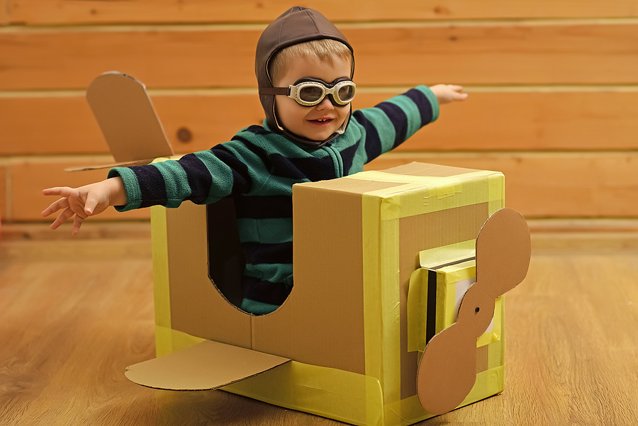 child in a box that looks like an airplane