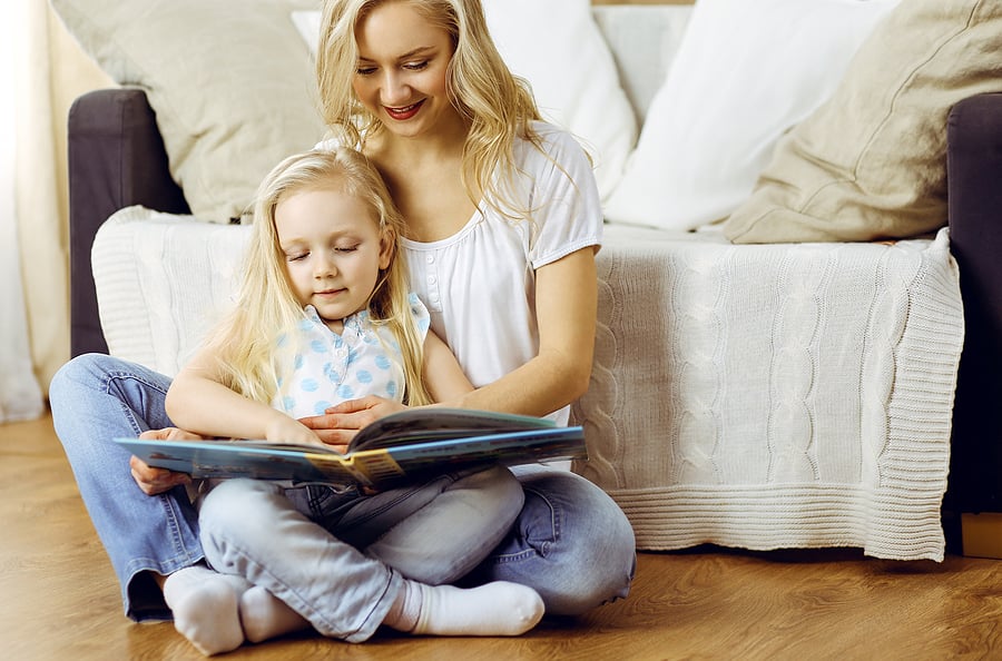 Mom reading a book to her child