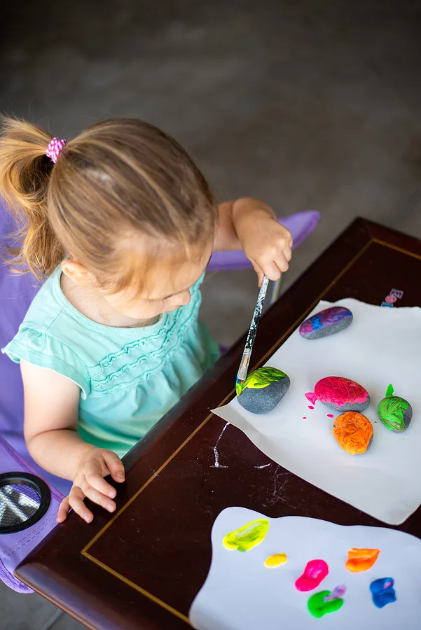 Child painting rocks