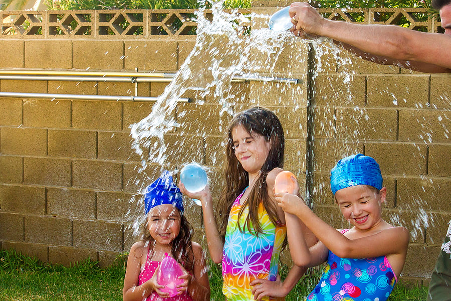 Children having a water balloon fight