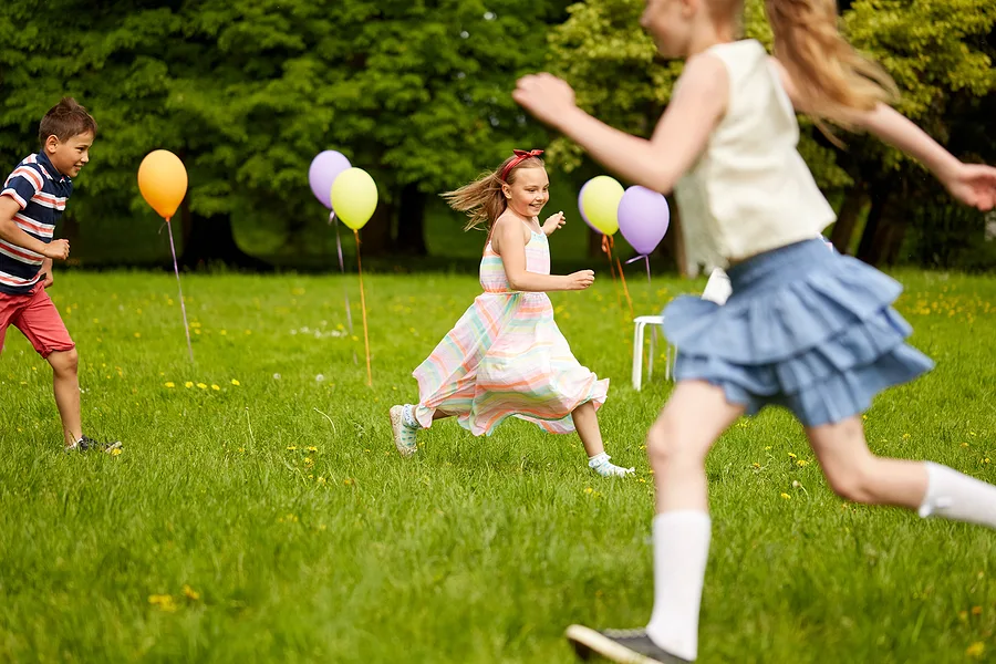 Children chasing each other at a party