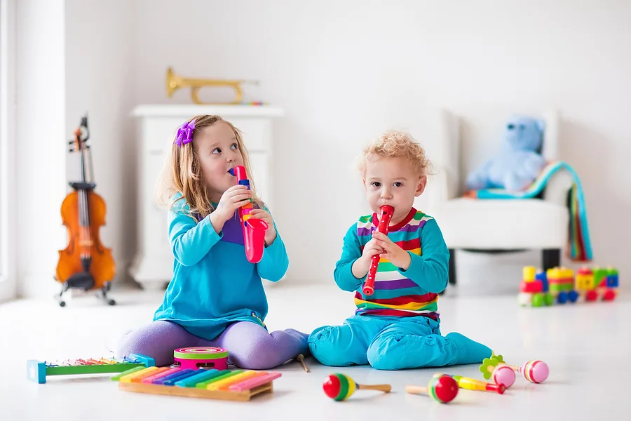 Children playing toy musical instruments