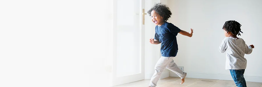 Young siblings chasing each other