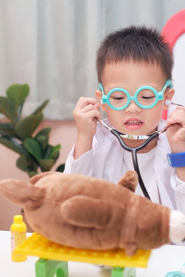 child dressing up like a vet pretend play