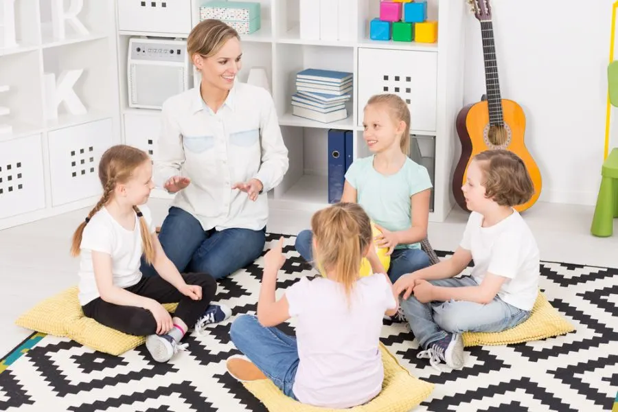 Children in a circle playing a clapping game