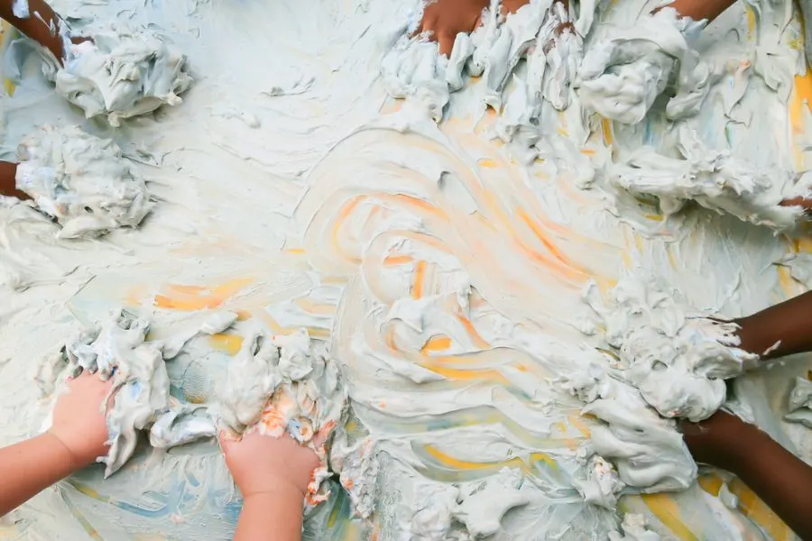 Kids playing in colorful shaving cream