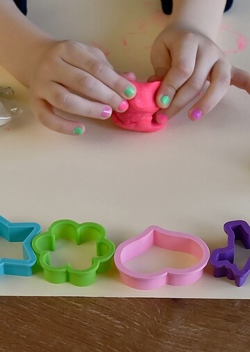 girl making something with playdough