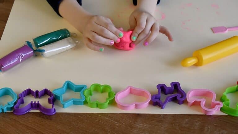 girl making something with playdough