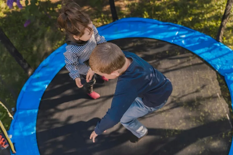 Children jumping on trampoline