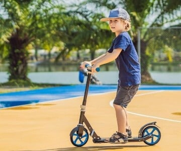 preschooler riding a scooter