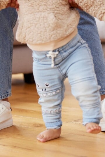 baby learning to walk with mom