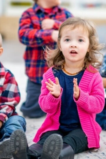 Preschool children sitting on the floor during circle time.